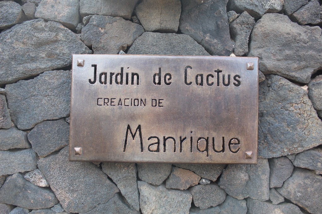 Guatiza, Spain – October 18, 2020: Sign in the Cactus Garden by Cesar Manrique on Lanzarote Island. It’s written “Cactus Garden by Cesar Manrique (in English). 