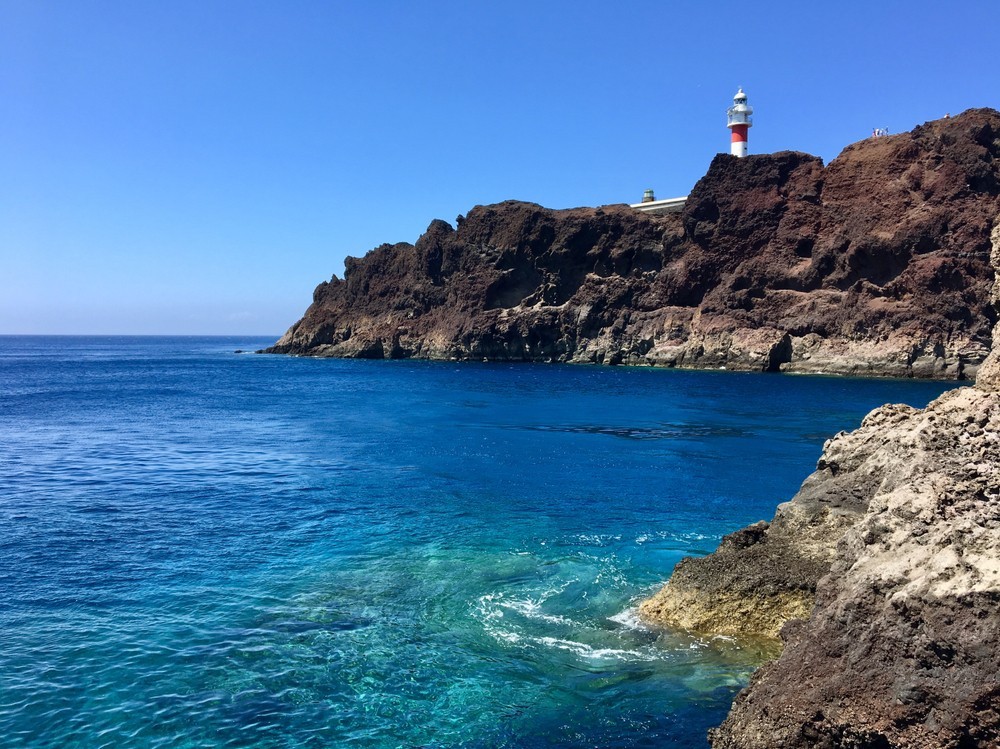 Beautiful seascape of Tenerife Island. Clear blue water of Atlantic Ocean and steep cliffs near Teno lighthouse. Punta Teno, Buenavista del Norte, Tenerife, Canary Islands, Spain.