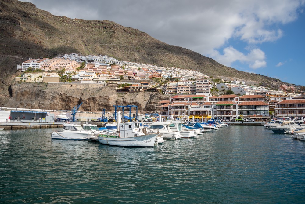 Los Gigantes - March 21, 2018: Marina Los Gigantes and a view of the majestic rock formations - the Giants cliffs. Tenerife, Canary Islands, Spain