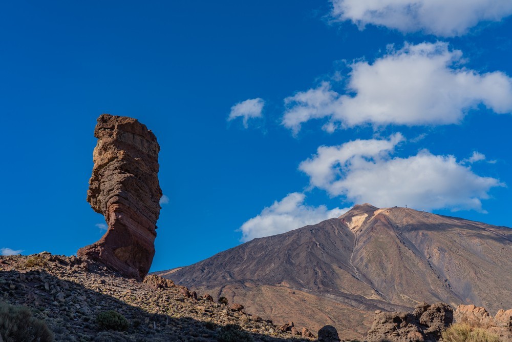 View of unique Roques de Garcia rock formation in the background of Pico del Teide. Teide National Park, Tenerife, Canary Islands, Spain. Teide National Park, Tenerife, Canary Islands, Spain.