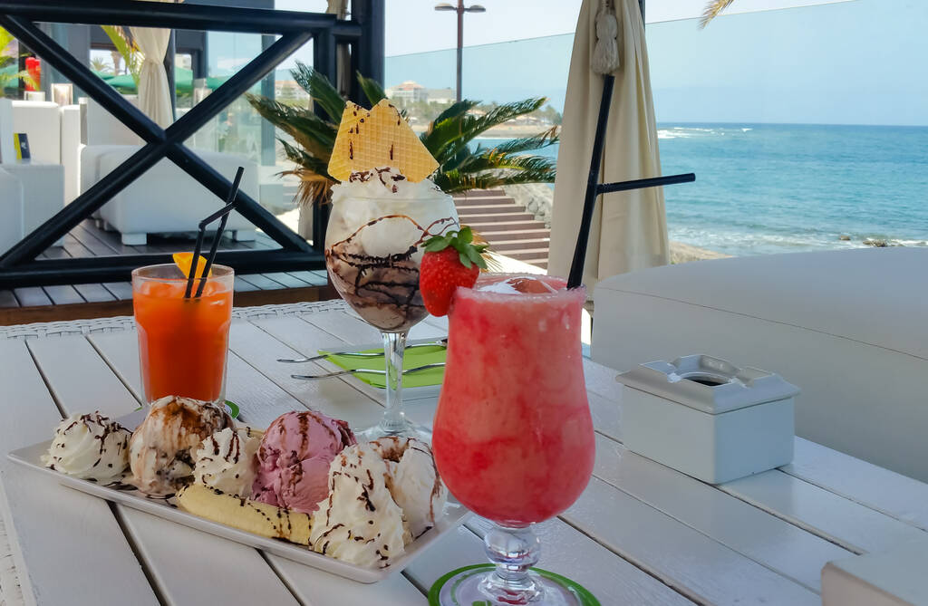Colorful cocktails and ice cream on a terrace by the ocean in a beautiful exotic destination in Canary Islands, Tenerife, Spain.