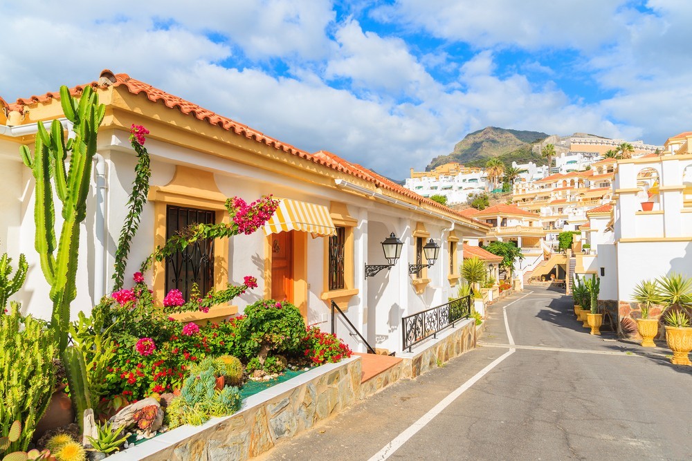 Street with typical Canary style holiday apartments in Costa Adeje, Tenerife, Canary Islands, Spain