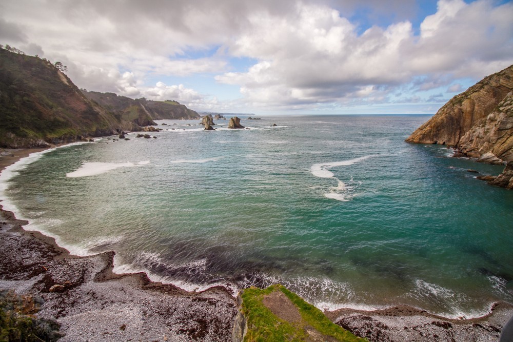 View of the beautiful beach Playa del Silencio in Northern Spain on a cloudy day in a mysterious light