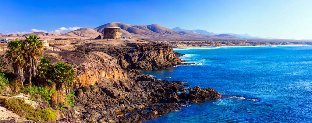 landscapes of volcanic Fuerteventura - view with Toston tower in El Cotillo. Canary islands of Spain