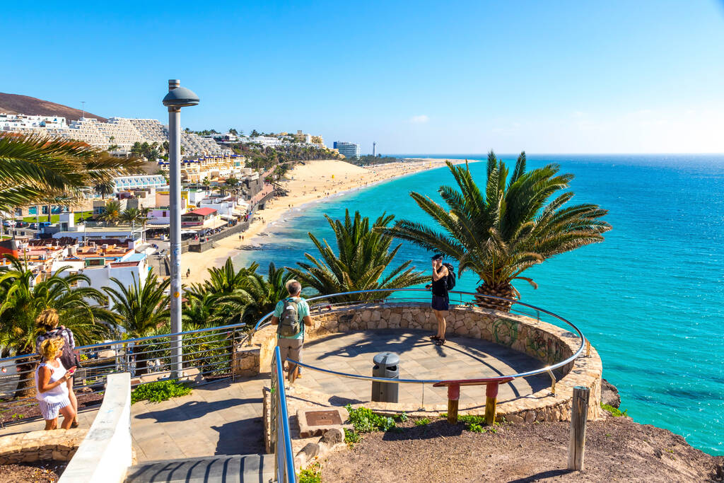 Canaries, Spain - December 9, 2018: Viewpoint above the Morro Jable beach on Fuerteventura island, Canary Islands, Spain. One of the best beach in the Canaries. Motorral lighthouse in distance