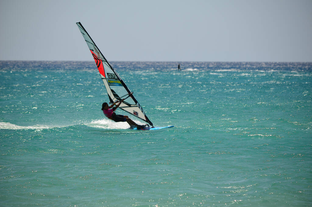 FUERTEVENTURA, CANARY ISLANDS - JULY 2019 - Unidentified windsurfer in action at Playa Barca in Costa Calma