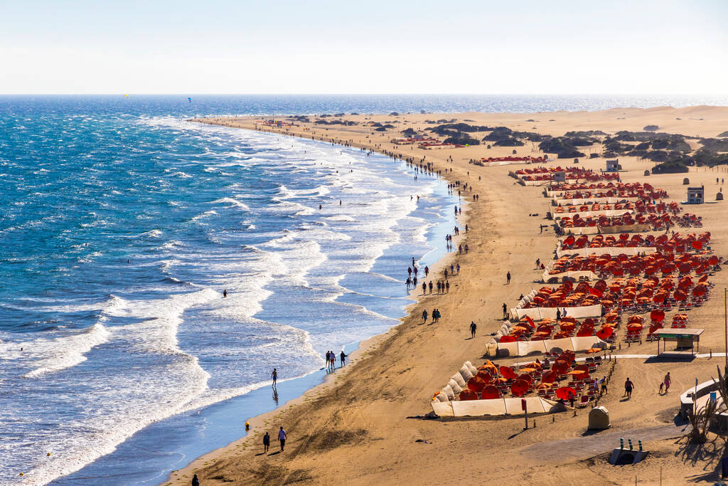 Maspalomas Beach (Playa de Maspalomas) on the south part of Gran Canaria island, Canary Islands, Spain. Famous for its photogenic giant sand dunes, which provide the backdrop for a magnificent beach
