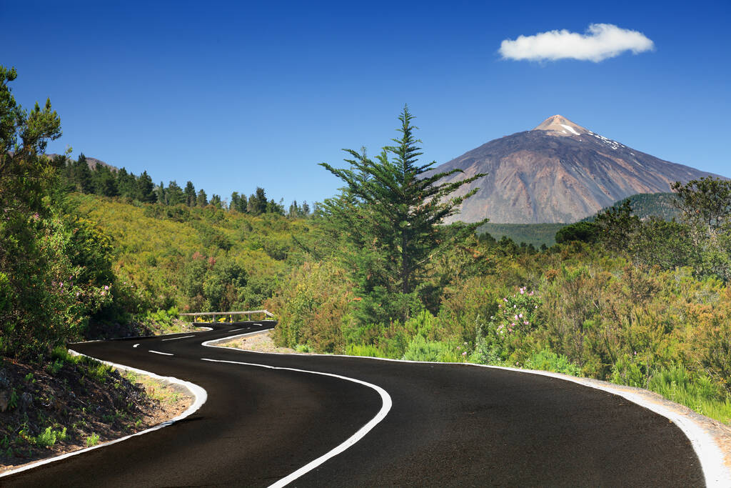 Open road on Tenerife. Winding mountain road in beautiful landscape on Tenerife showing the volcano Teide.