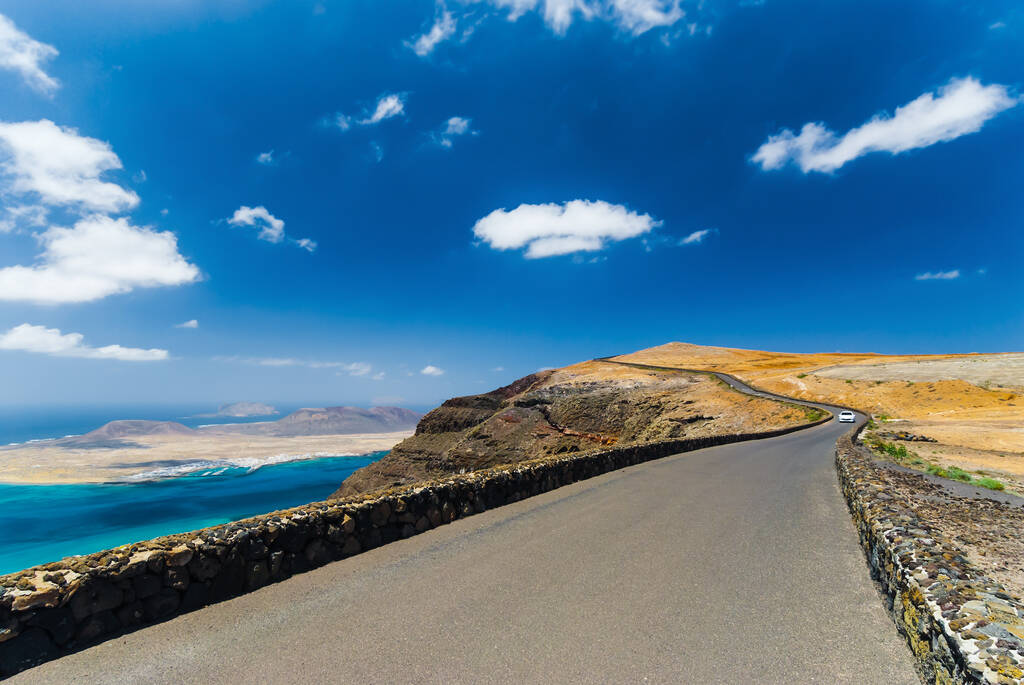 The road to the top of the mountain Mirador del Rio on background blue sky. Lanzarote. Canary Islands. Spain