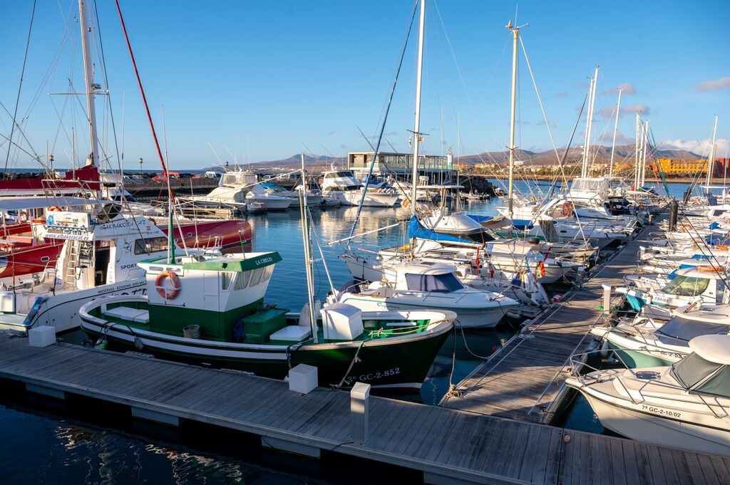 Fuerteventura, Hiszpania, 28 lutego 2023 r., Jachty i łodzie w porcie zatoki oceanicznej Fuerteventura w słoneczny dzień, licencja: shutterstock/By CinemaPhoto